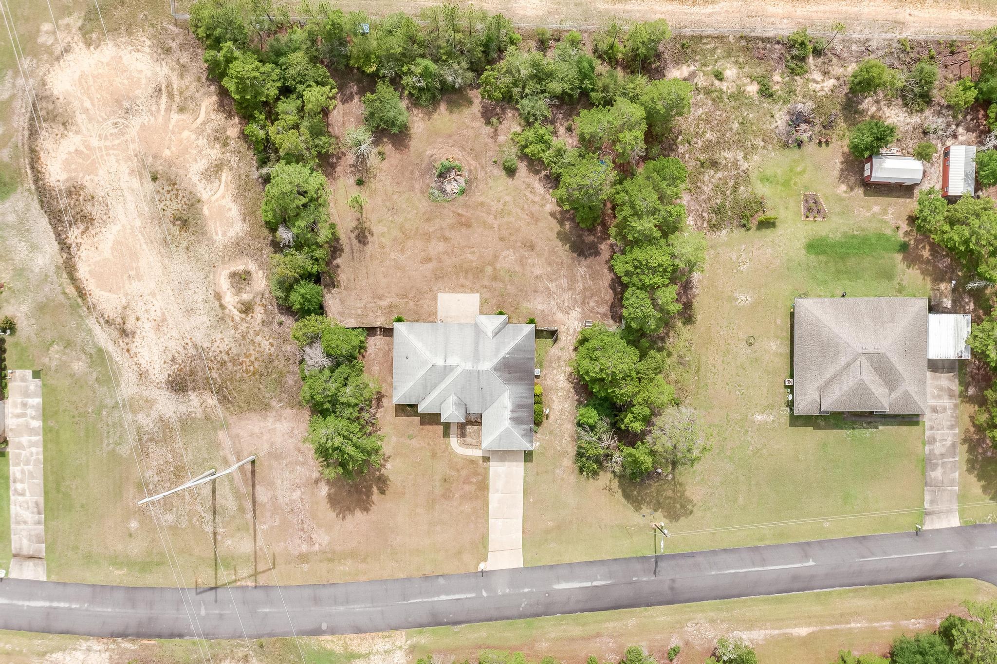 4140 Big Buck Trail Crestview, FL 32539 - Photo 39 of 40 an aerial view of a house with a yard and trees