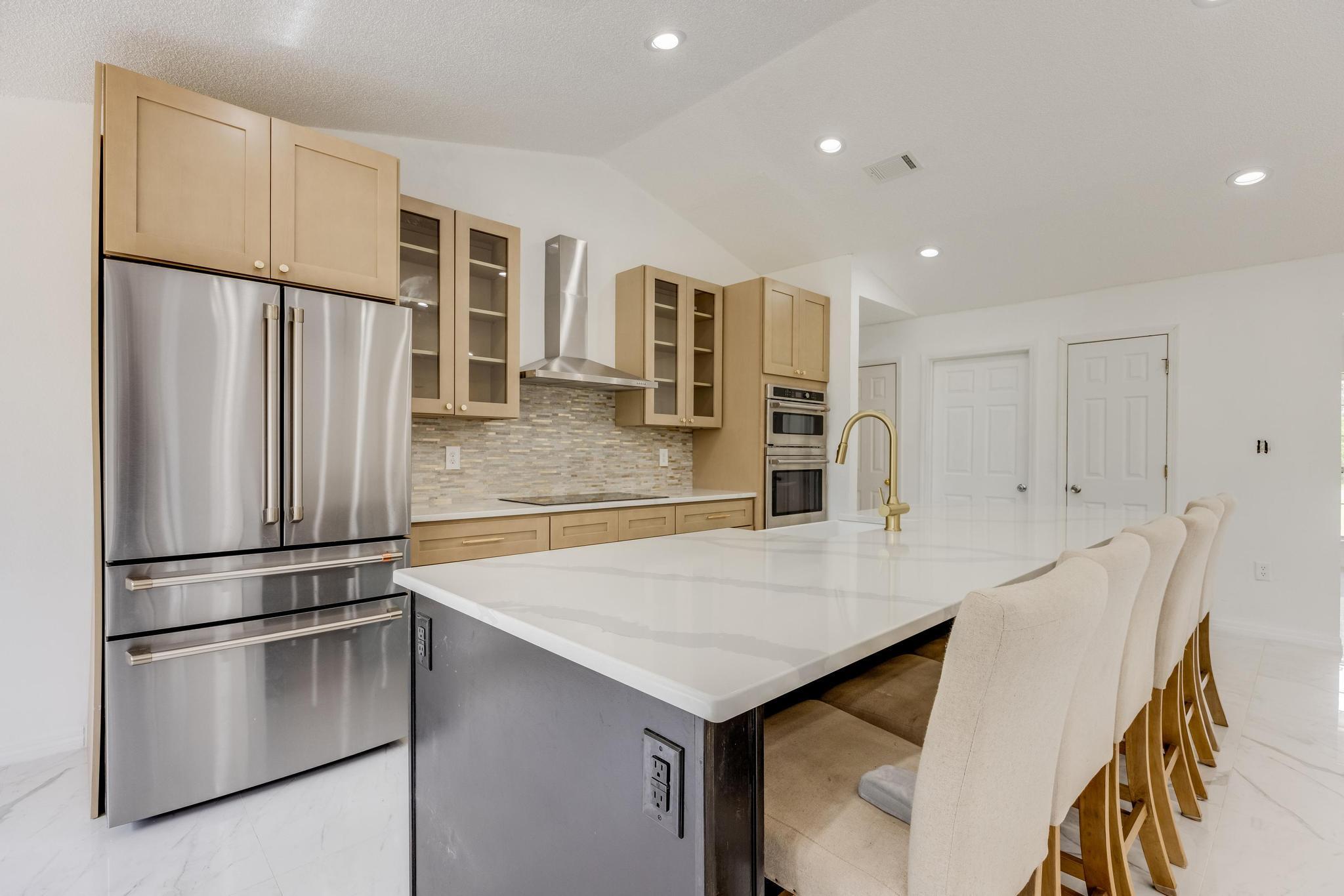 4140 Big Buck Trail Crestview, FL 32539 - Photo 8 of 40 a kitchen with stainless steel appliances a refrigerator and a stove top oven