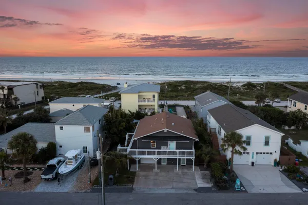 a kitchen with stainless steel appliances a sink a stove top oven a chimney and a center island