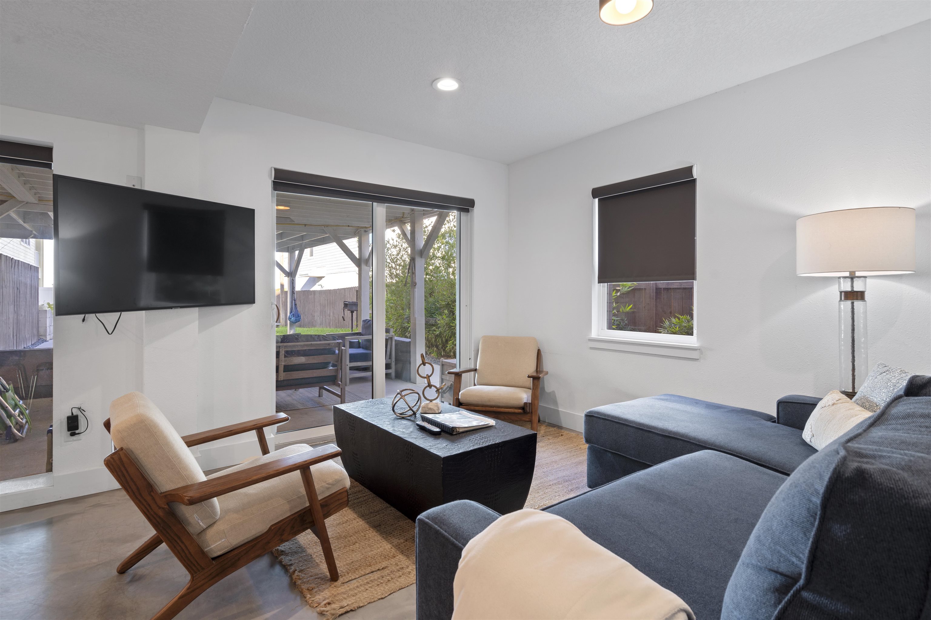 5730 Rudolph Avenue St. Augustine, FL 32080 - Photo 37 of 72 a living room with furniture a flat screen tv and a large window
