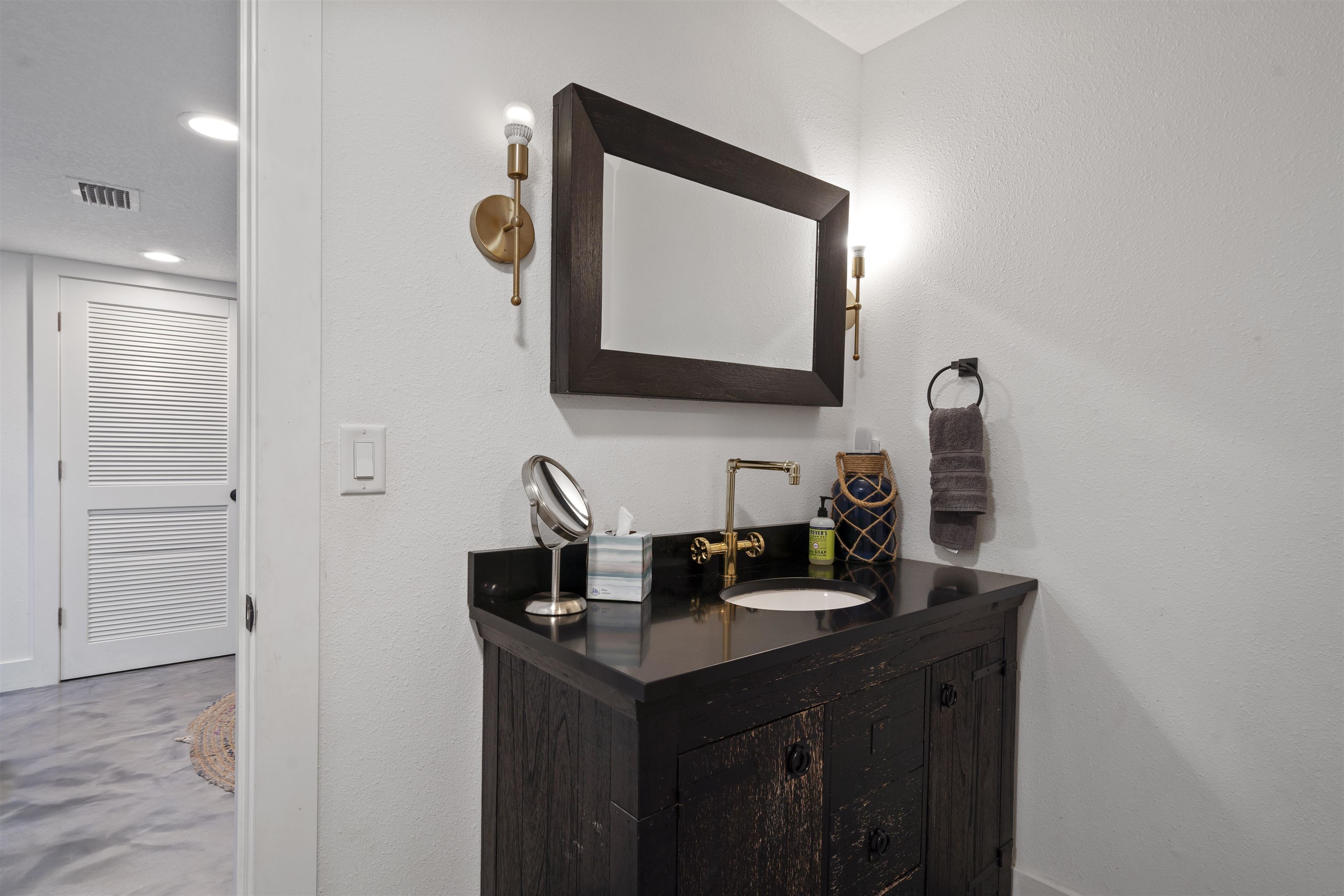 5730 Rudolph Avenue St. Augustine, FL 32080 - Photo 48 of 72 a bathroom with a sink and a mirror