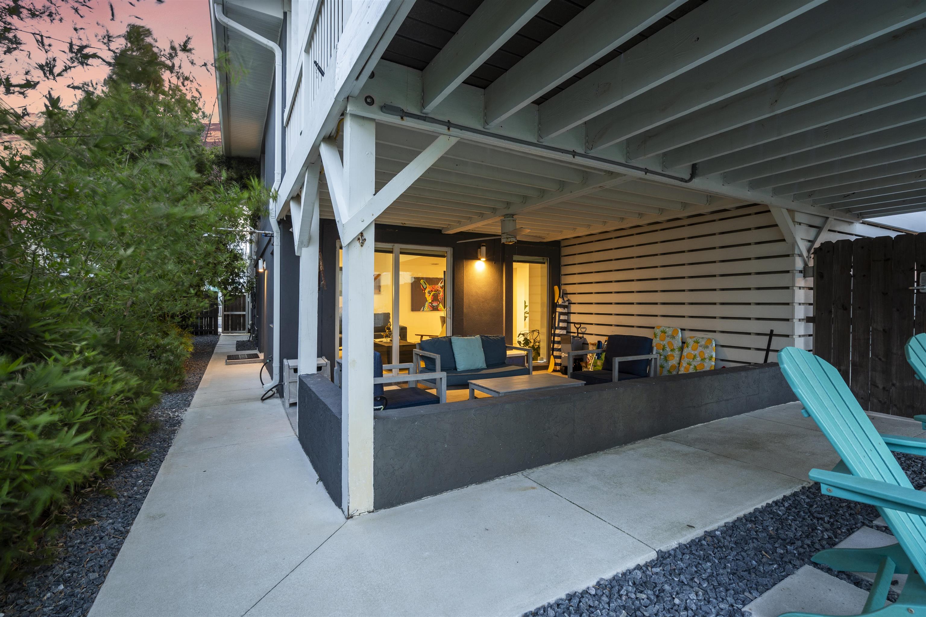 5730 Rudolph Avenue St. Augustine, FL 32080 - Photo 50 of 72 a view of a patio with table and chairs potted plants with floor to ceiling window and wooden fence