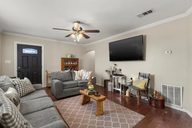 a living room with furniture and a flat screen tv