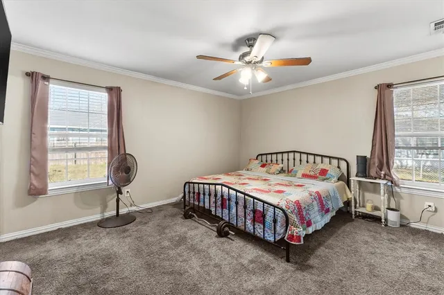 a bedroom with a bed lamp and a window