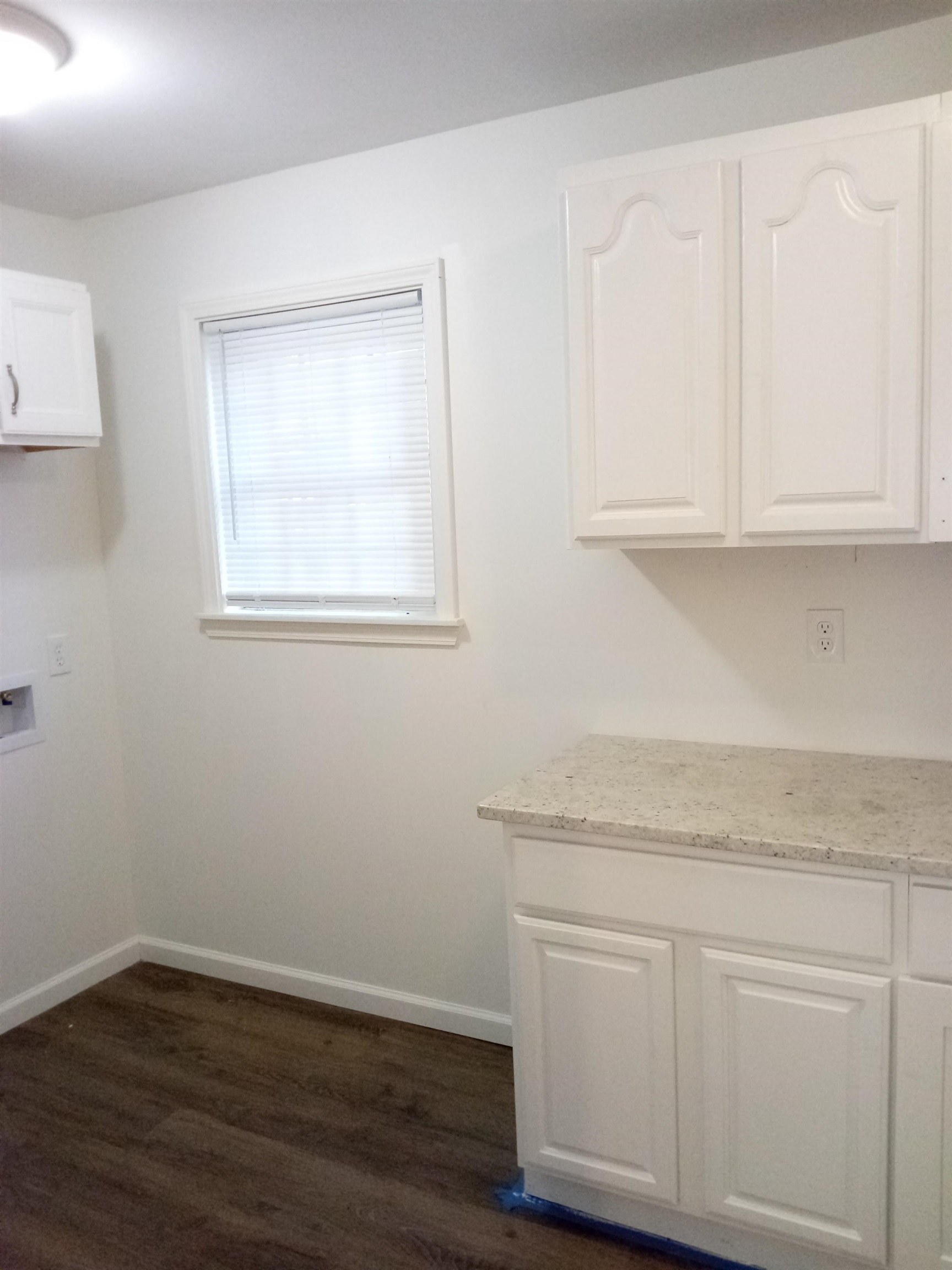 4425 Hodge Road Memphis, TN 38109 - Photo 18 of 37 a room with white cabinets and wooden floor