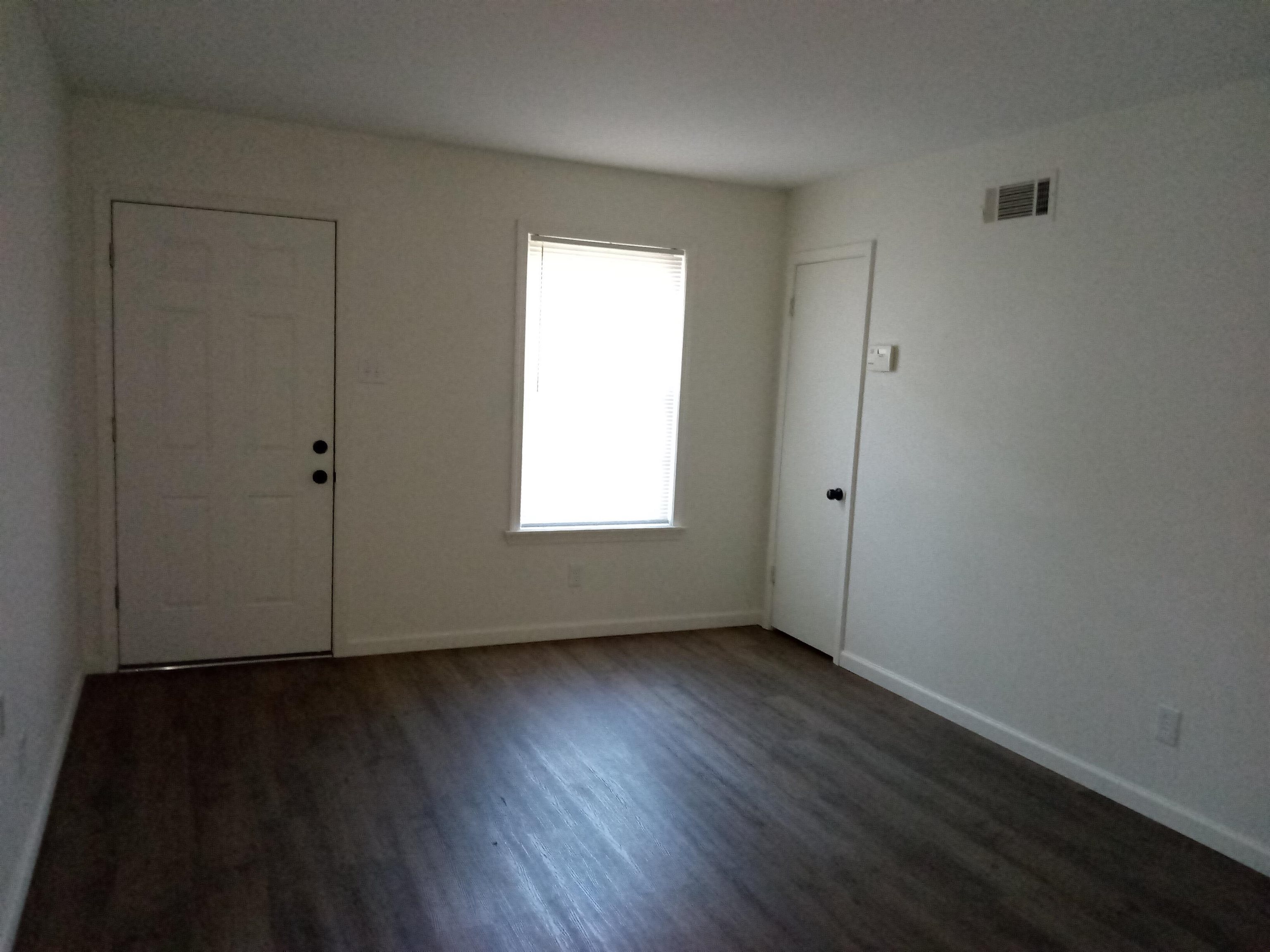4425 Hodge Road Memphis, TN 38109 - Photo 2 of 37 an empty room with wooden floor and window