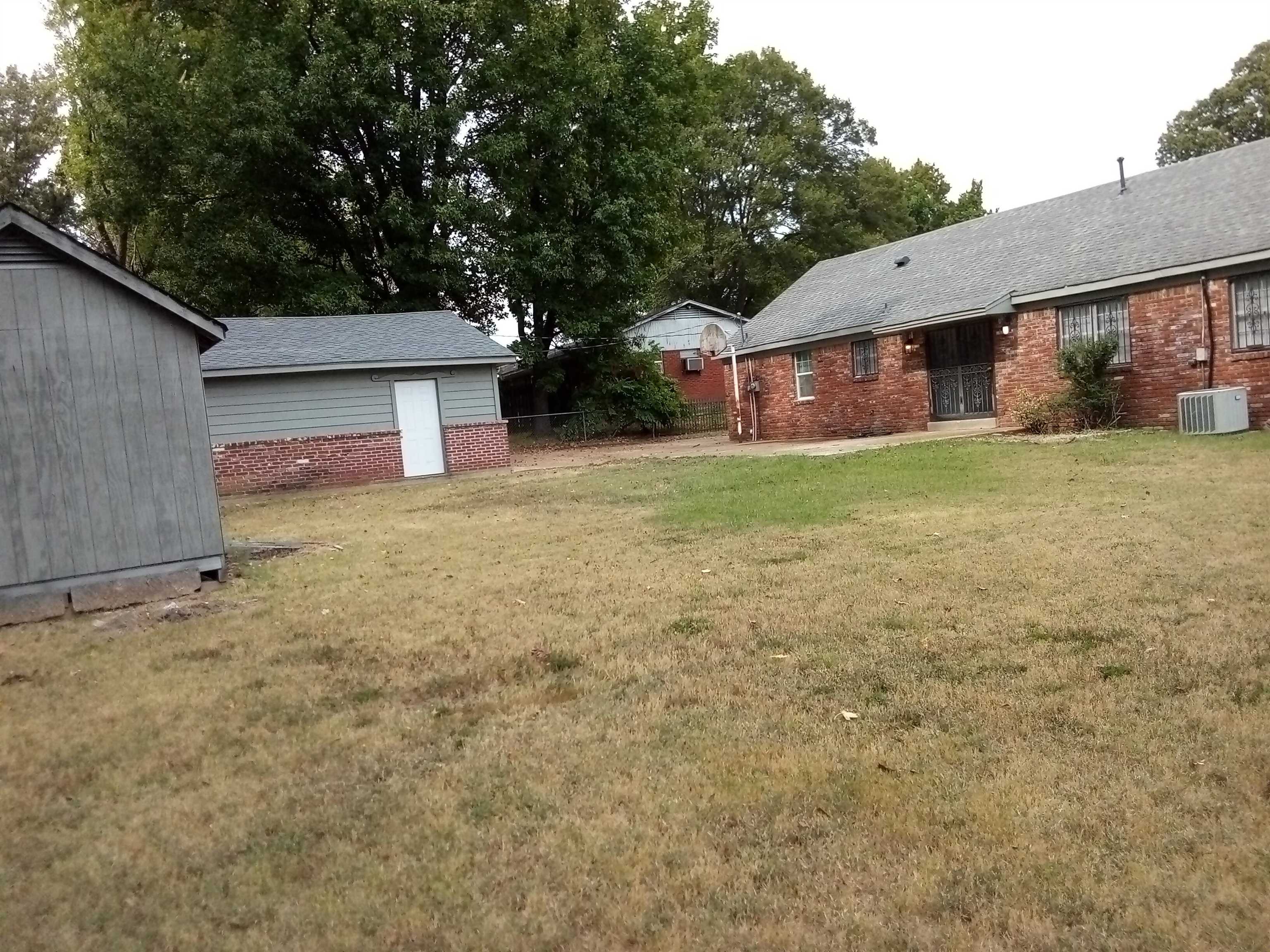 4425 Hodge Road Memphis, TN 38109 - Photo 31 of 37 a view of a house with a backyard