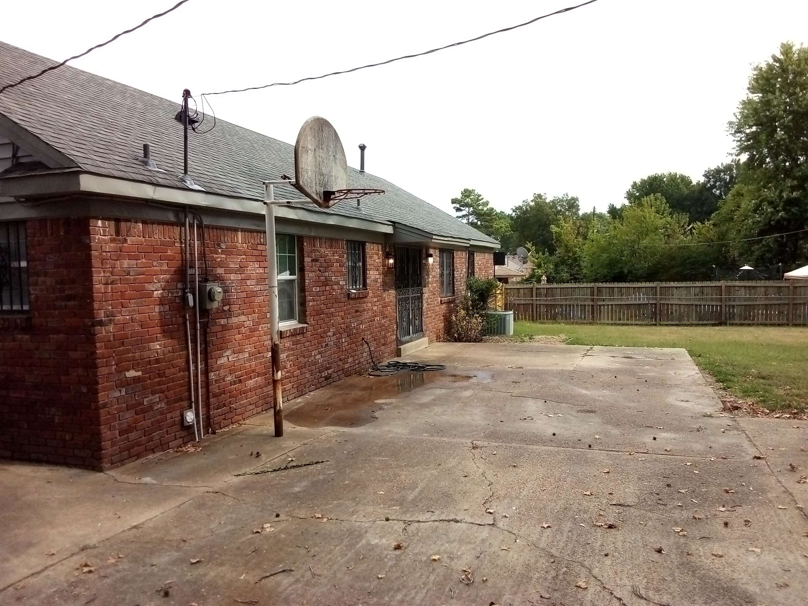 4425 Hodge Road Memphis, TN 38109 - Photo 32 of 37 a backyard of a house with a bench and trees