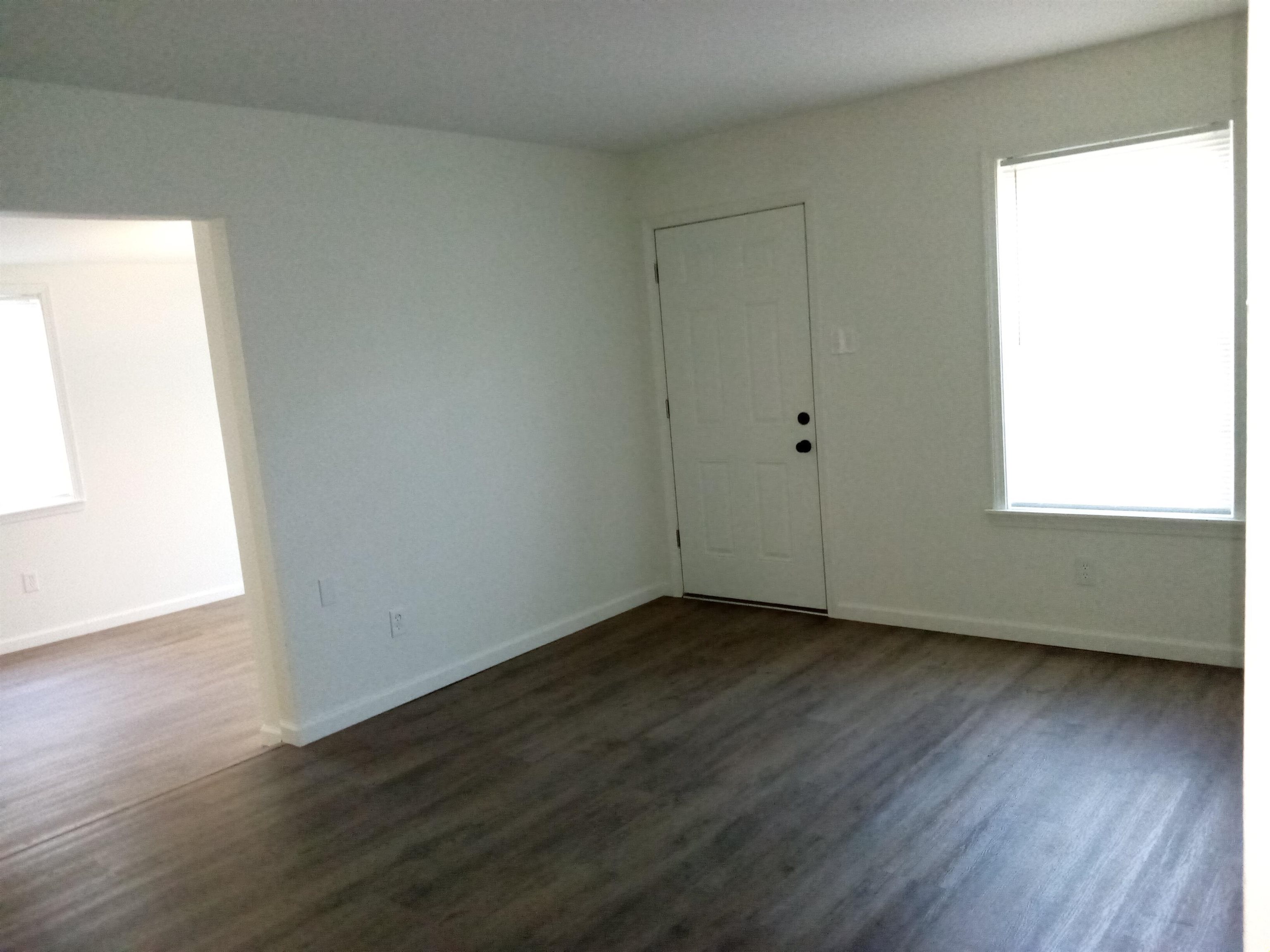 4425 Hodge Road Memphis, TN 38109 - Photo 4 of 37 an empty room with wooden floor and windows