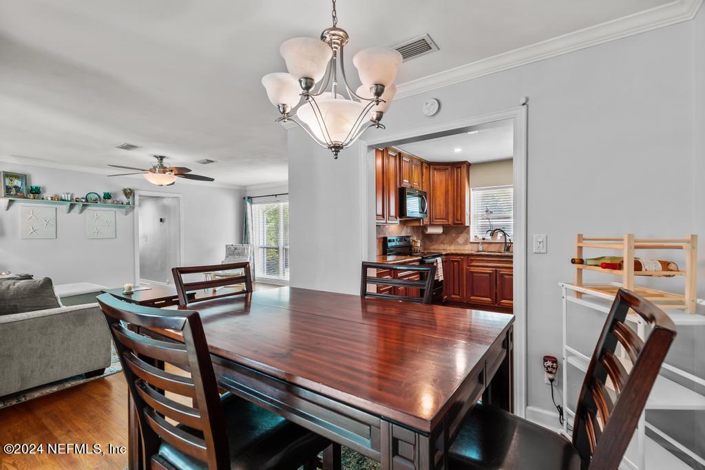 3645 Marianna Road Jacksonville, FL 32217 - Photo 15 of 44 a view of a dining room with furniture and a chandelier