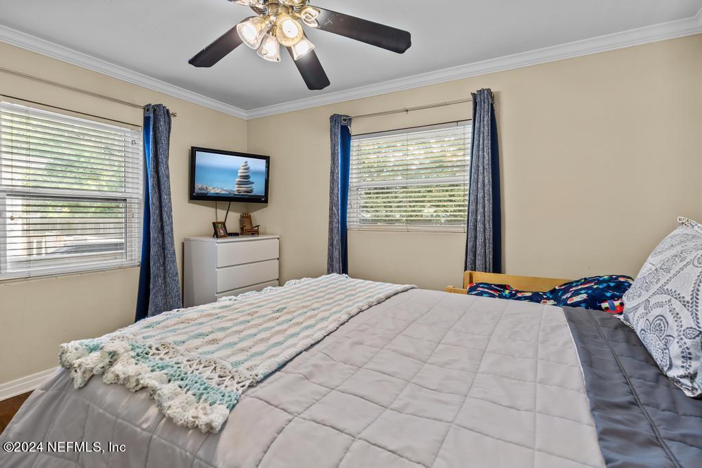 3645 Marianna Road Jacksonville, FL 32217 - Photo 17 of 44 a bedroom with a bed and a flat screen tv