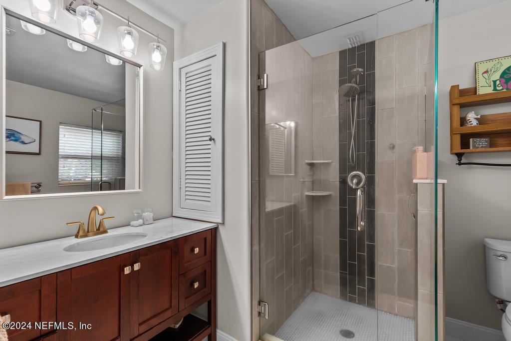 3645 Marianna Road Jacksonville, FL 32217 - Photo 19 of 44 a bathroom with a double vanity sink mirror and shower