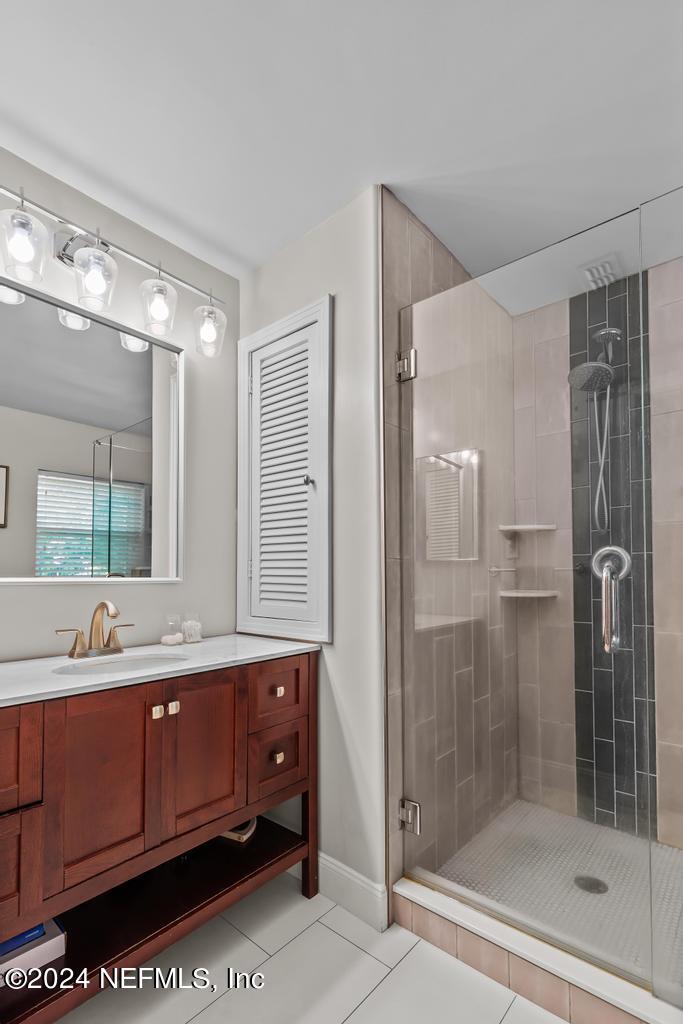 3645 Marianna Road Jacksonville, FL 32217 - Photo 20 of 44 a bathroom with a double vanity sink mirror and shower