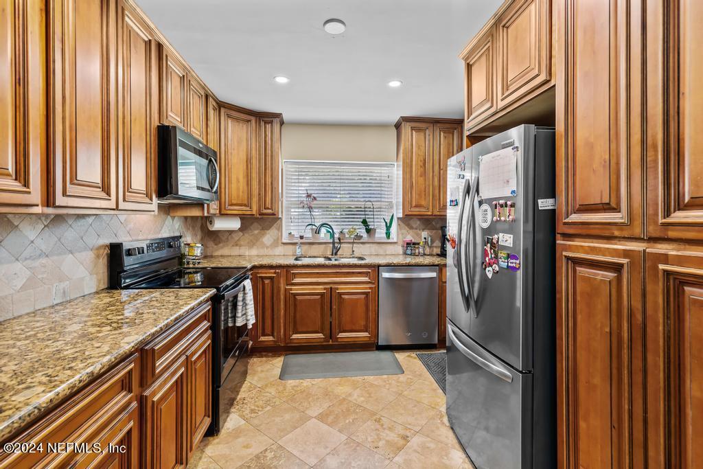 3645 Marianna Road Jacksonville, FL 32217 - Photo 9 of 44 a kitchen with a refrigerator a sink and a stove