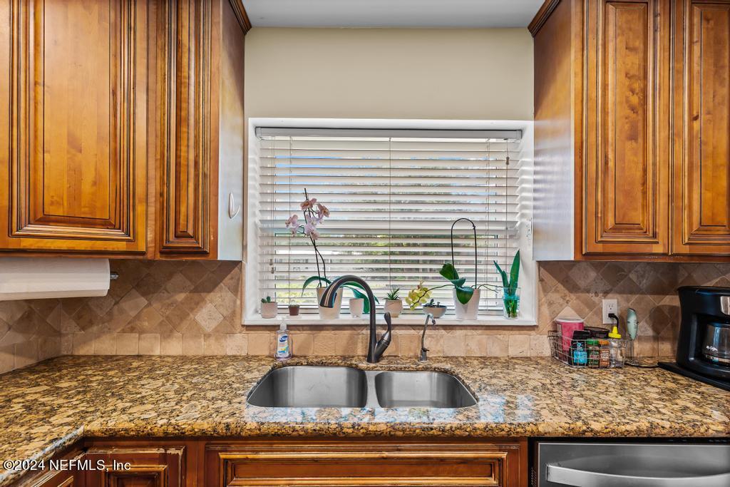 3645 Marianna Road Jacksonville, FL 32217 - Photo 10 of 44 a kitchen with granite countertop a sink and a window