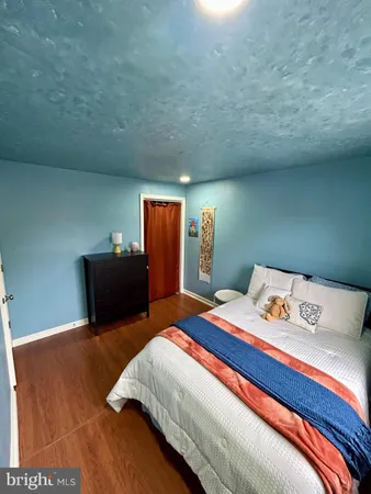 a bedroom with a bed and dresser