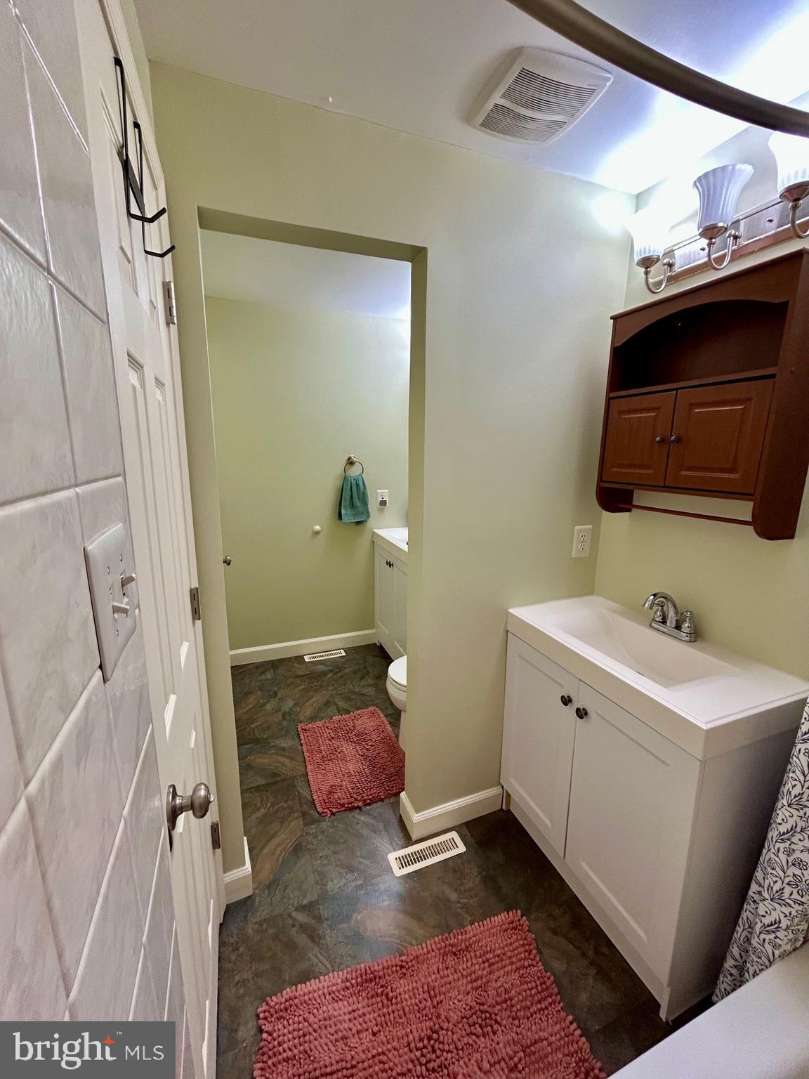 1007 Cape Splitt Harbour Pasadena, MD 21122 - Photo 16 of 19 a en suite bathroom with a sink and mirror