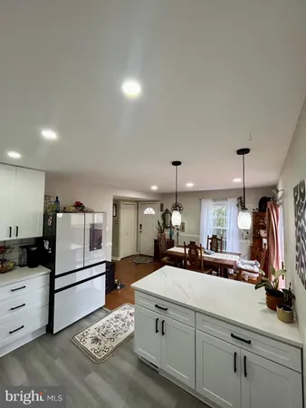 a large white kitchen with a stove a sink and dishwasher