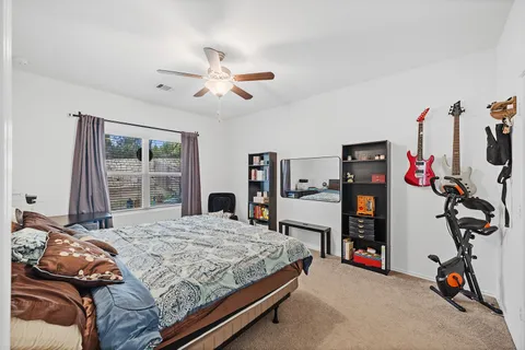 a view of kitchen center island stainless steel appliances wooden floor and living room view