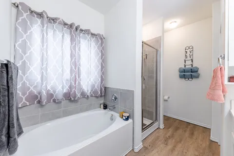 a bathroom with a double vanity sink mirror and shower