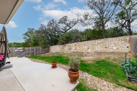 a view of a backyard with plants and a patio