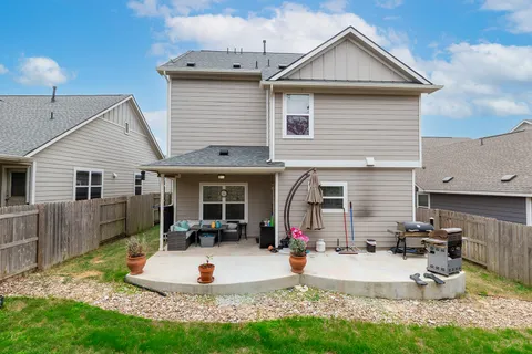 a view of a house with backyard and sitting area