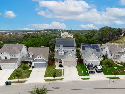 an aerial view of residential houses with outdoor space and street view
