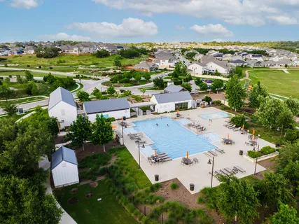an aerial view of residential houses with outdoor space and river