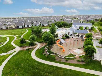 an aerial view of a house with garden space and outdoor seating