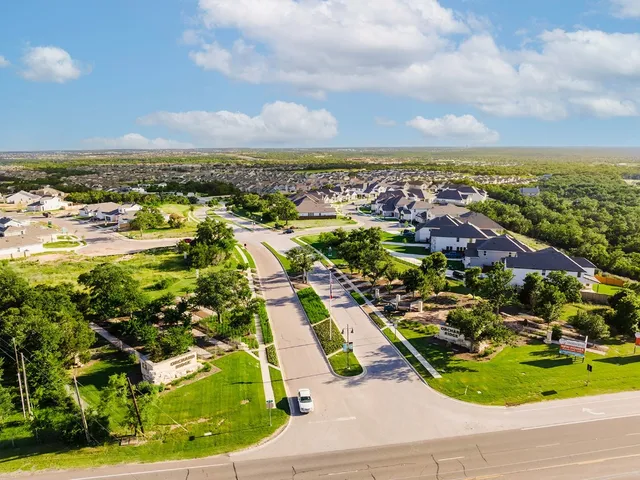an aerial view of residential houses with outdoor space