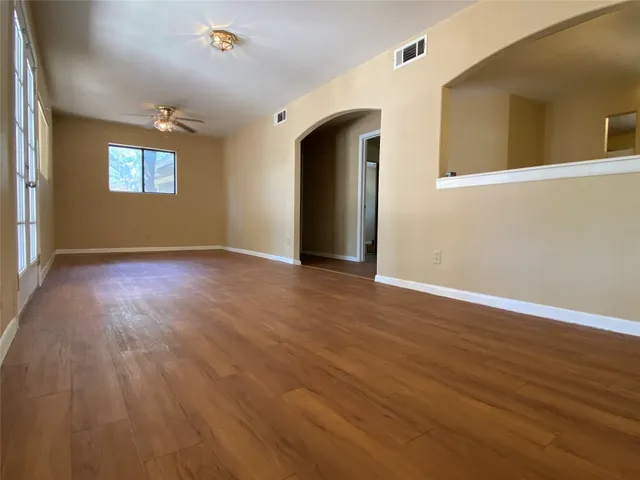 a kitchen with a sink a refrigerator a window and red cabinets