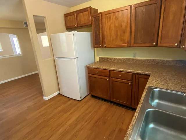 a utility room with wooden floor washer and dryer