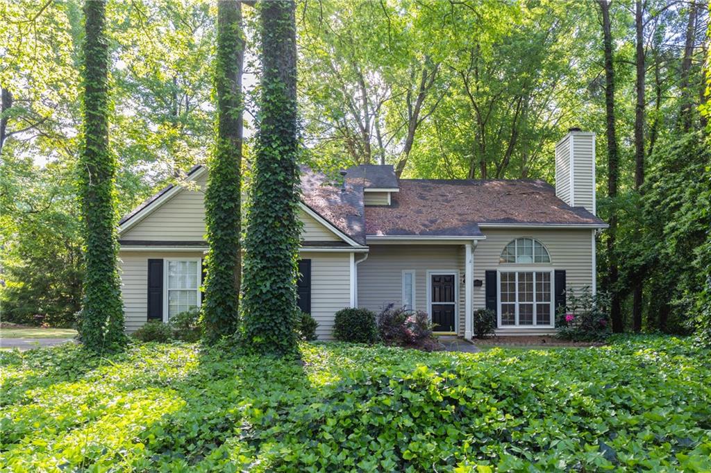 11355 Ridge Hill Drive Johns Creek, GA 30022 - Photo 1 of 1 a front view of a house with a garden