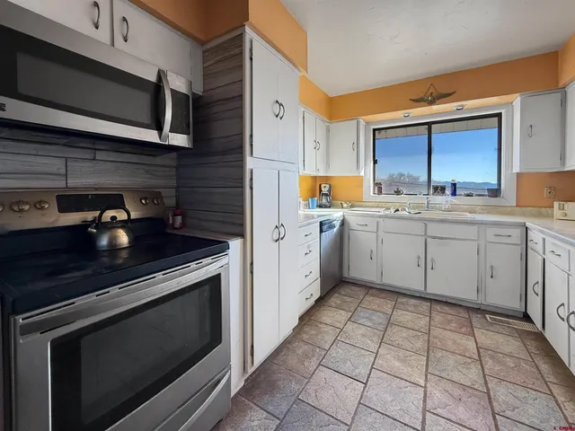 a kitchen with a sink stove and cabinets