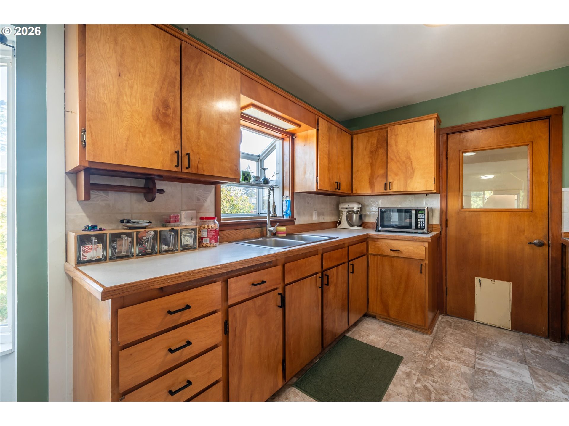 1789 14th Street North Bend, OR 97459 - Photo 17 of 43 a kitchen with stainless steel appliances granite countertop a sink and cabinets