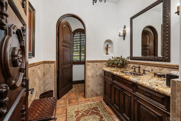 a bathroom with double vanity sink and a mirror