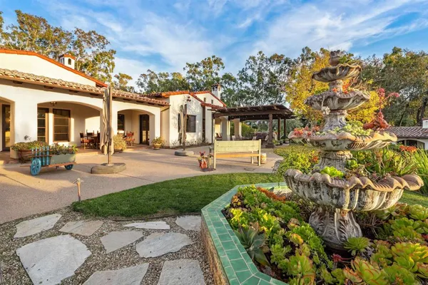 a front view of a house with garden