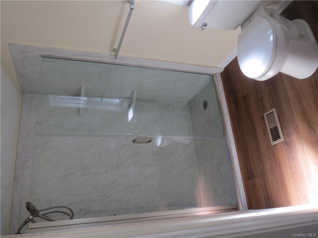 723 Beekman Road Hopewell Junction, NY 12533 - Photo 16 of 33 Bathroom featuring toilet, walk in shower, and wood-type flooring