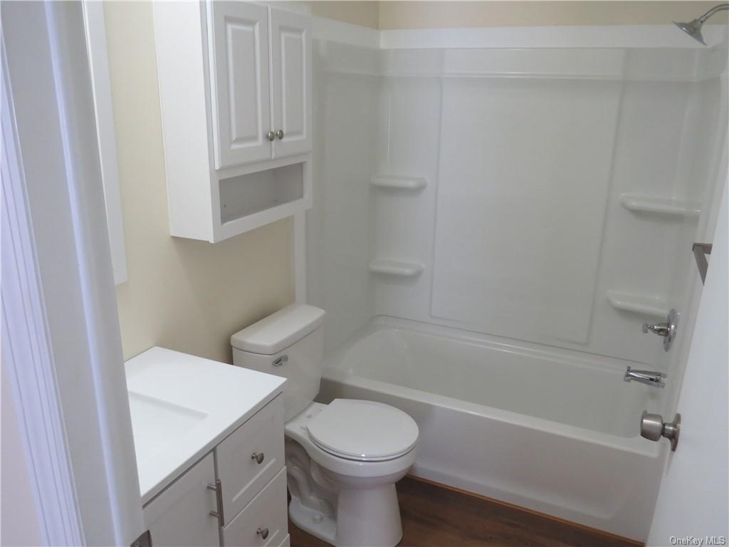 723 Beekman Road Hopewell Junction, NY 12533 - Photo 25 of 33 Full bathroom with vanity, hardwood / wood-style floors, shower / washtub combination, and toilet