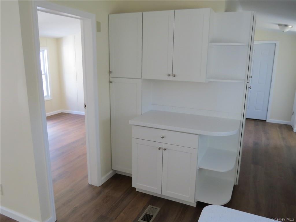 723 Beekman Road Hopewell Junction, NY 12533 - Photo 31 of 33 Kitchen featuring white cabinets and dark hardwood / wood-style flooring