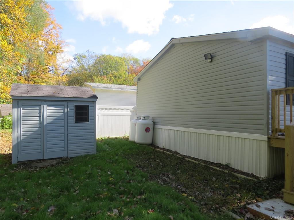 723 Beekman Road Hopewell Junction, NY 12533 - Photo 5 of 33 View of side of home with a yard and a shed