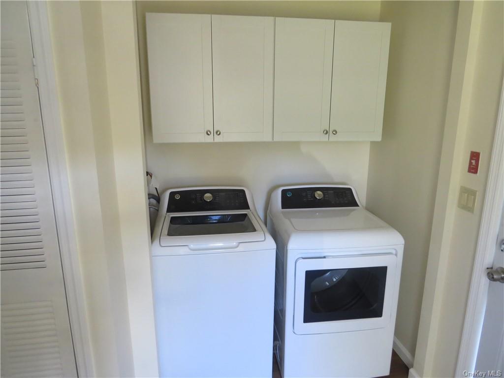 723 Beekman Road Hopewell Junction, NY 12533 - Photo 8 of 33 Washroom featuring washer and clothes dryer and cabinets