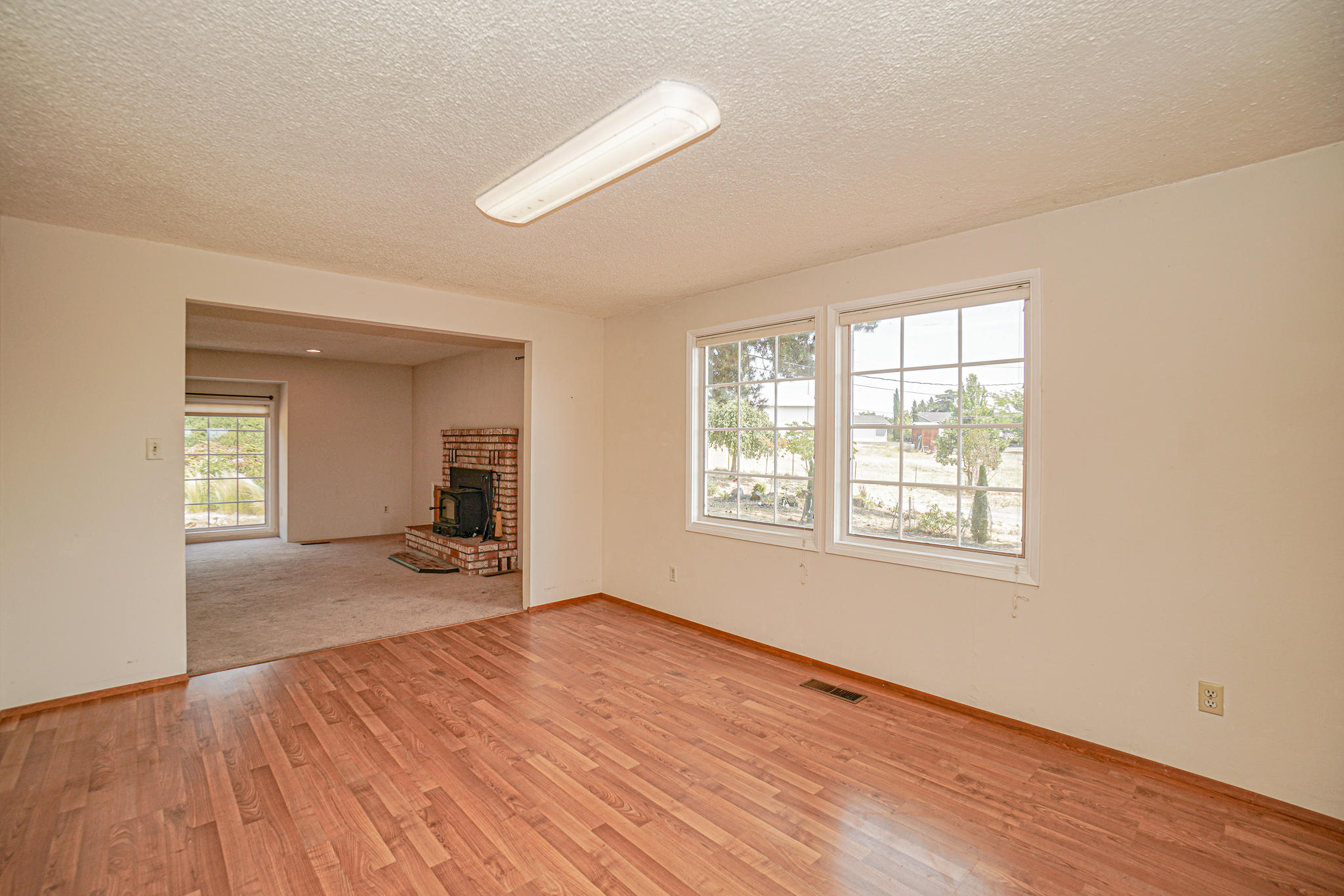 3632 Willow Springs Road Central Point, OR 97502 - Photo 7 of 36 a view of empty room with wooden floor and fan