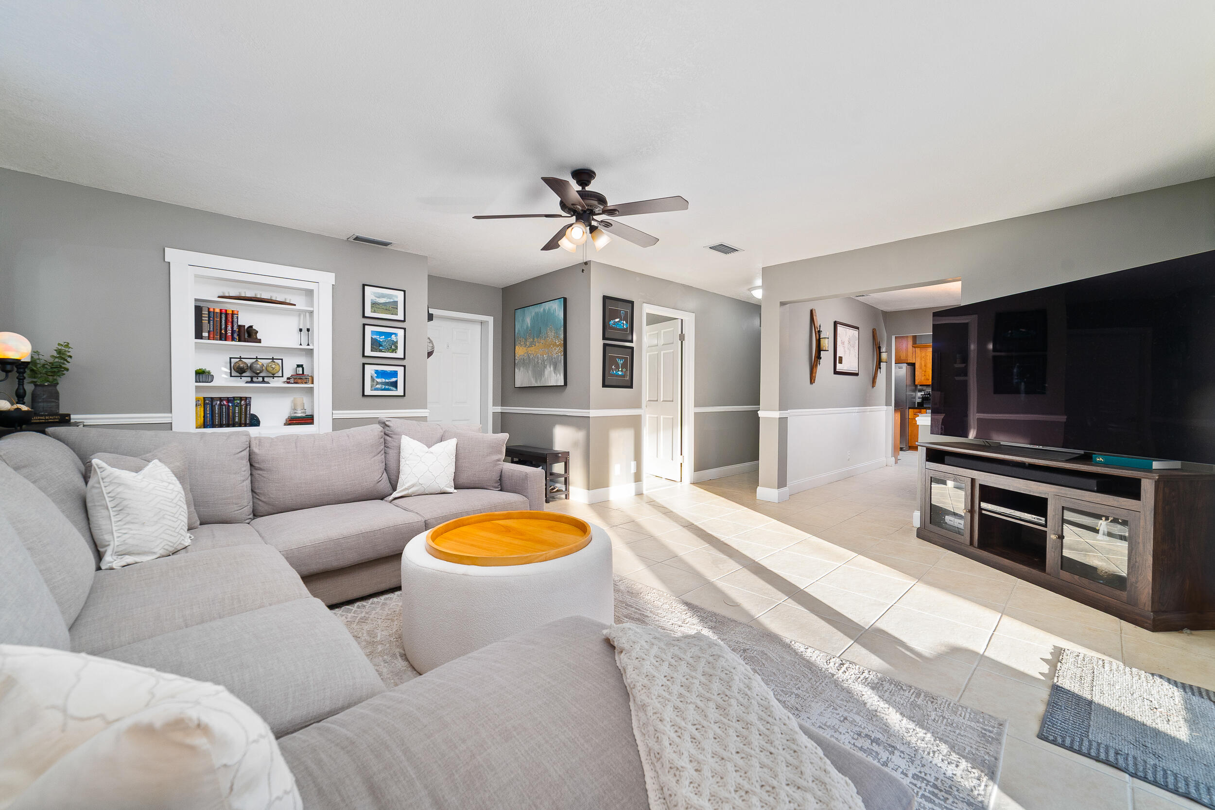 1045 Raintree Lane Wellington, FL 33414 - Photo 16 of 43 a living room with furniture and a flat screen tv