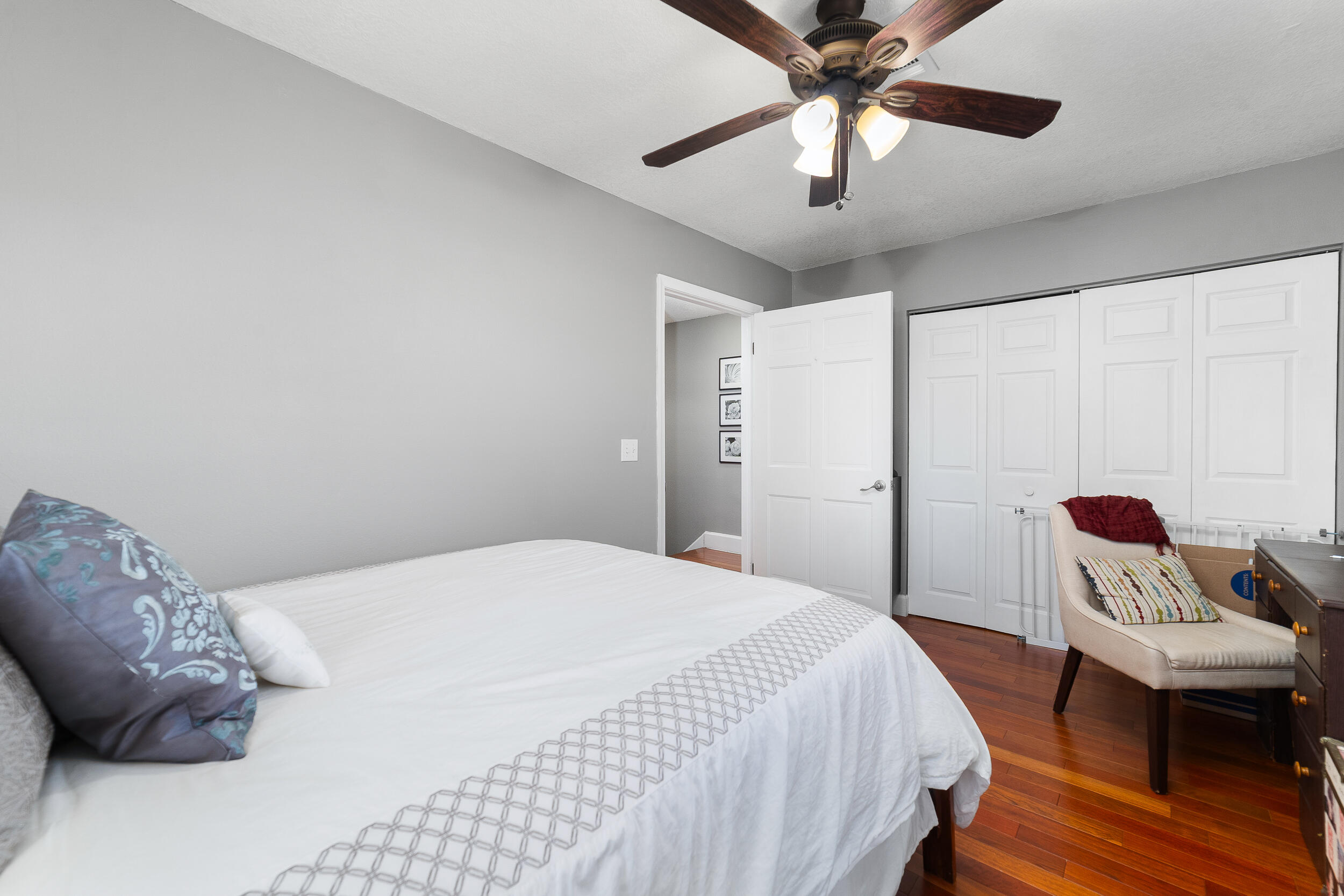 1045 Raintree Lane Wellington, FL 33414 - Photo 18 of 43 a bedroom with a bed and a chandelier