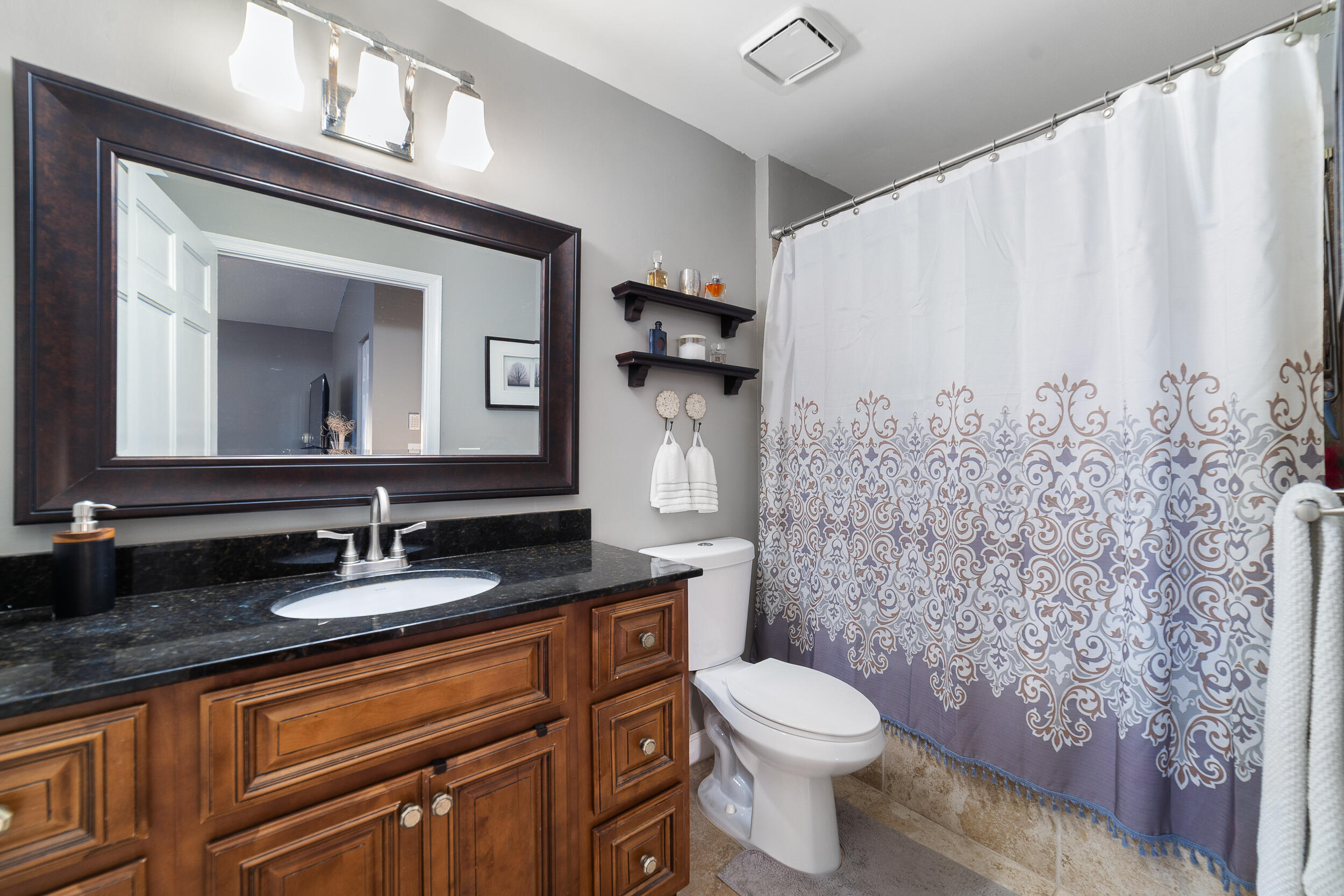 1045 Raintree Lane Wellington, FL 33414 - Photo 23 of 43 a bathroom with a granite countertop sink mirror and toilet