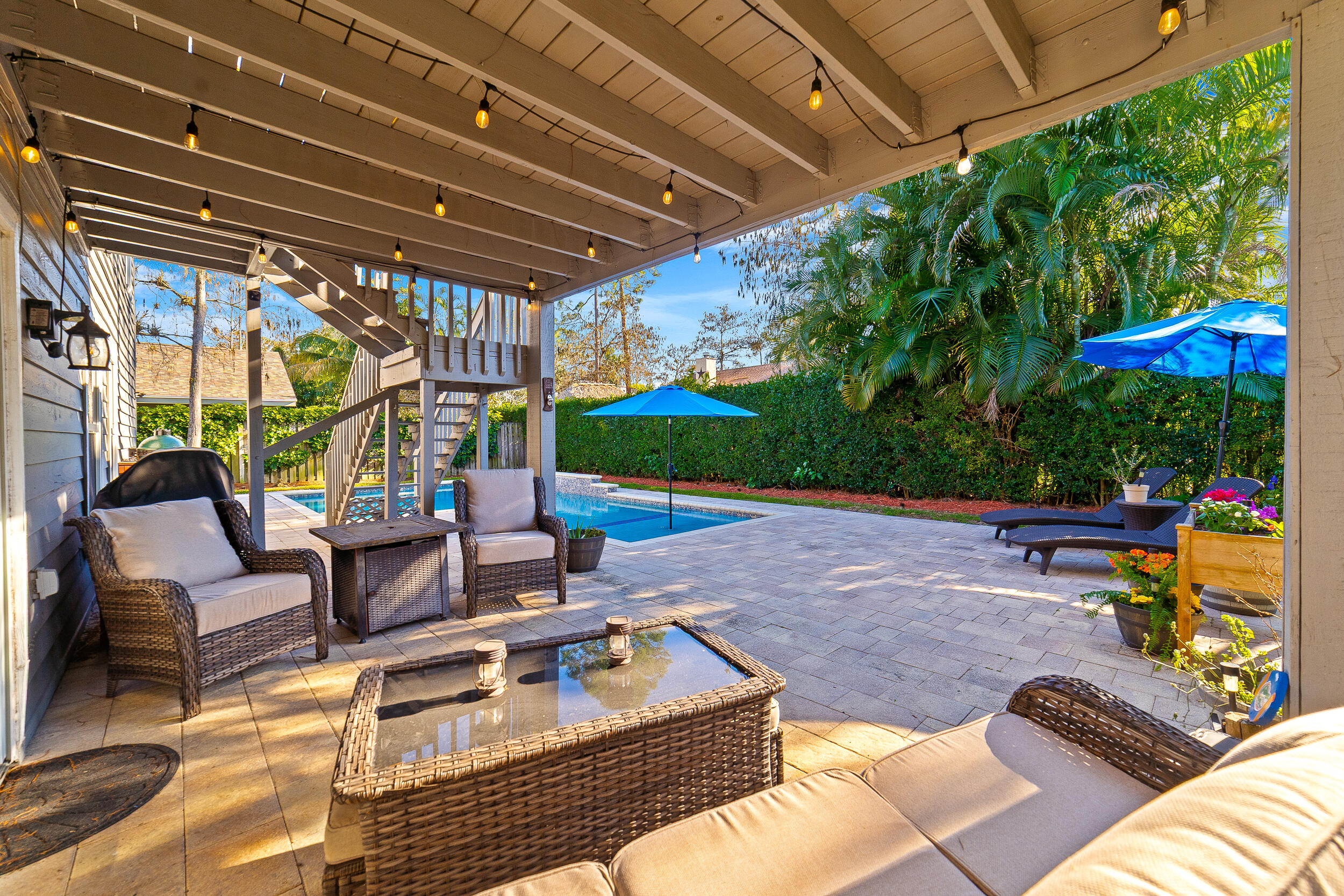 1045 Raintree Lane Wellington, FL 33414 - Photo 26 of 43 a view of a patio with table and chairs potted plants with wooden floor