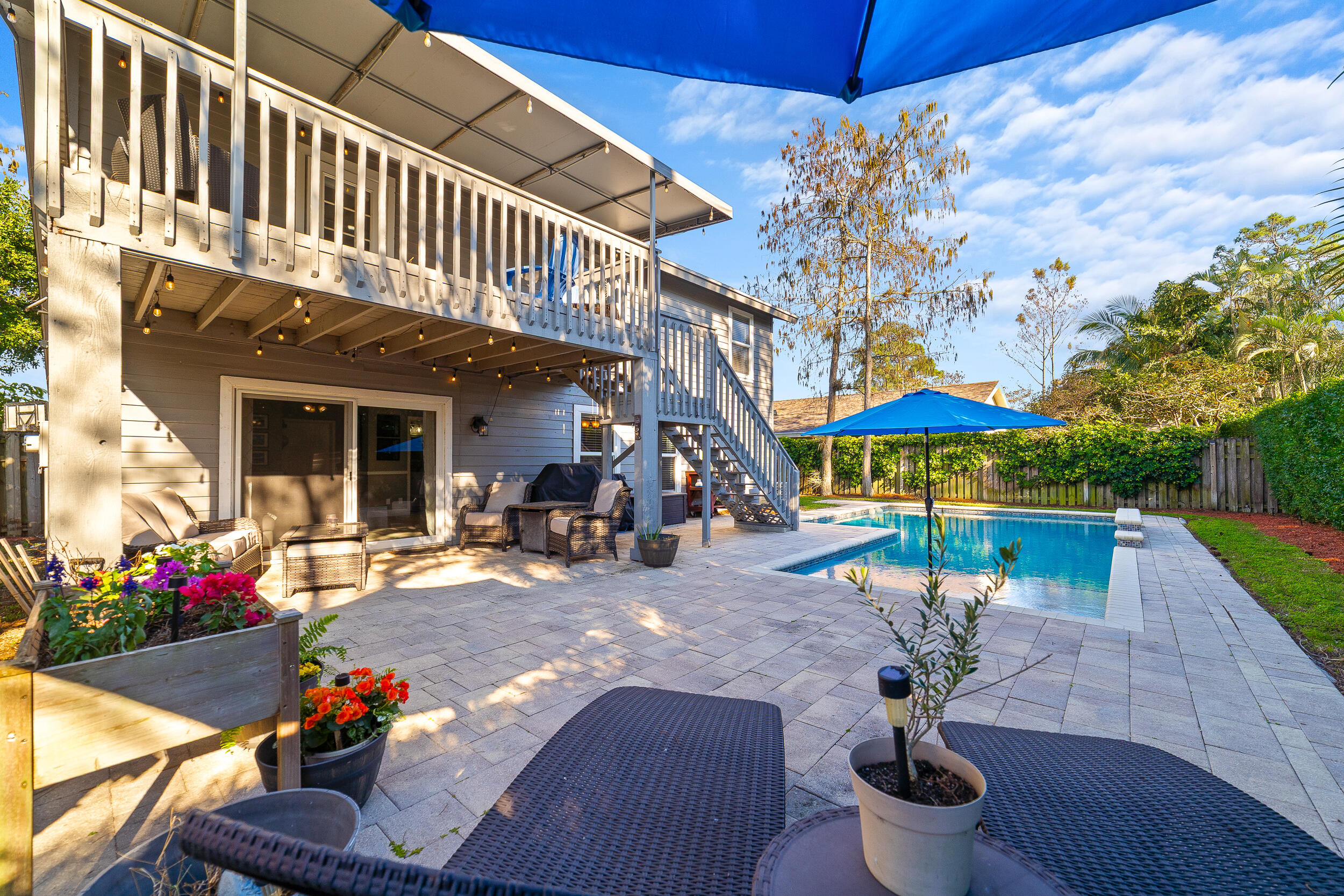 1045 Raintree Lane Wellington, FL 33414 - Photo 28 of 43 a view of a house with backyard water fountain and sitting area