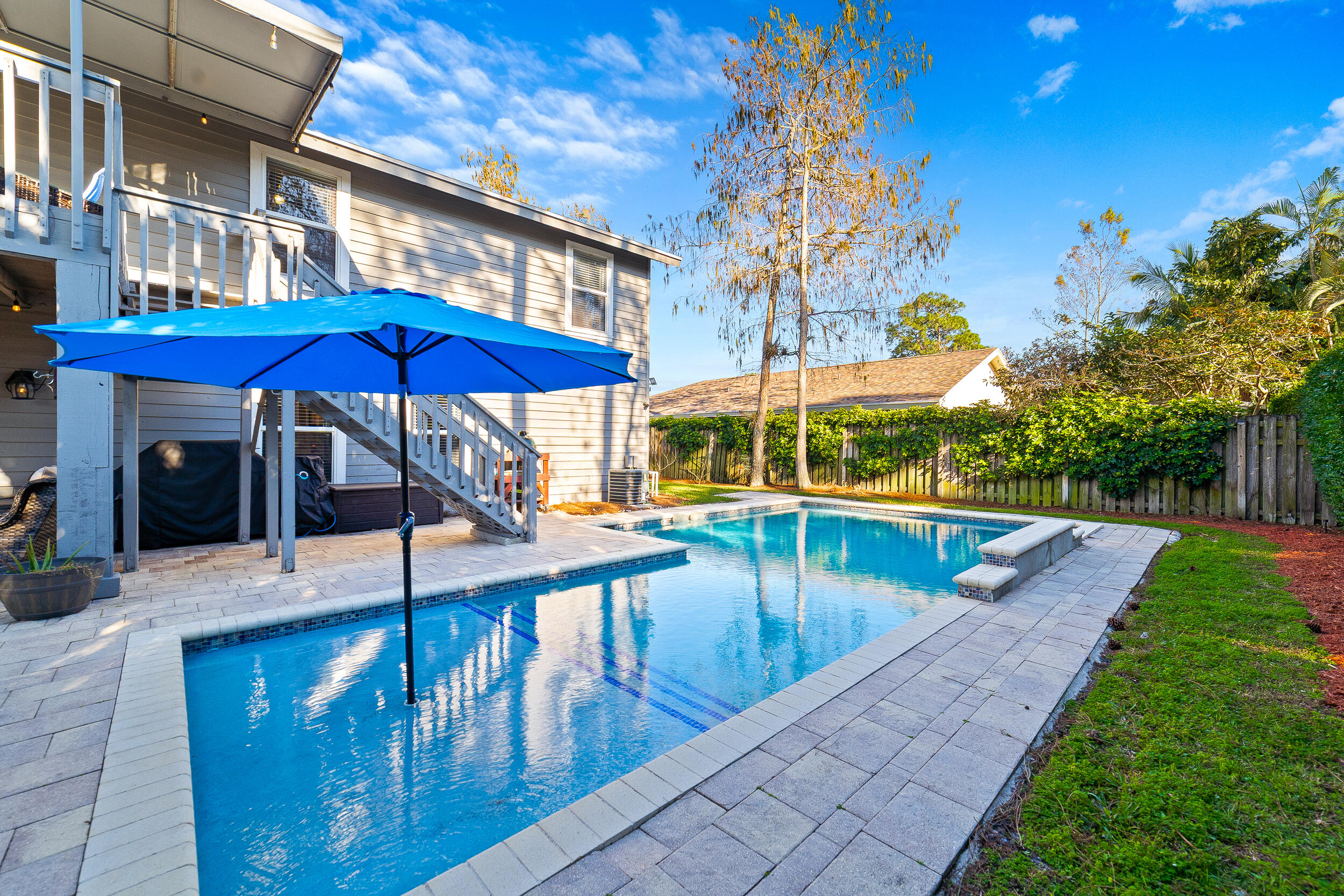 1045 Raintree Lane Wellington, FL 33414 - Photo 30 of 43 a view of a swimming pool with sitting area