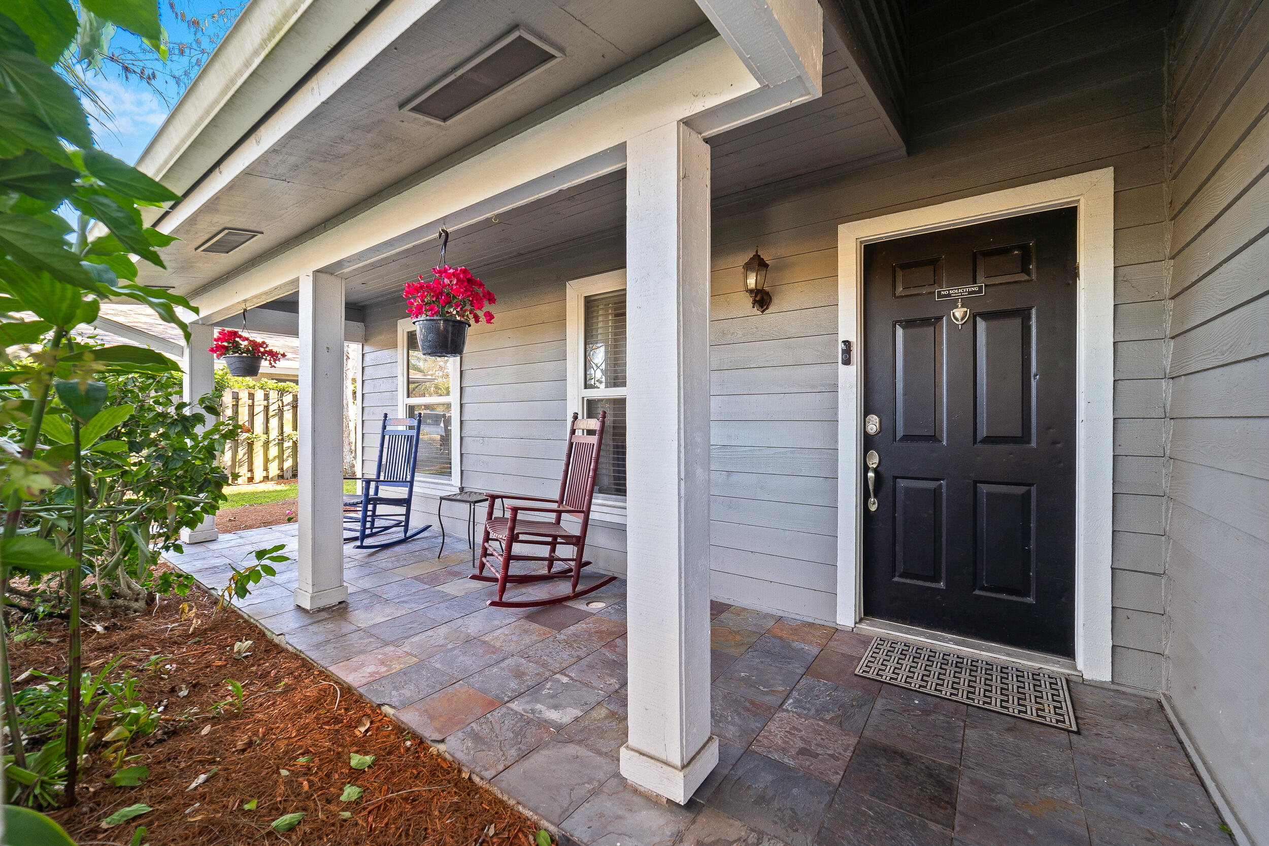 1045 Raintree Lane Wellington, FL 33414 - Photo 3 of 43 a front view of a house with a porch